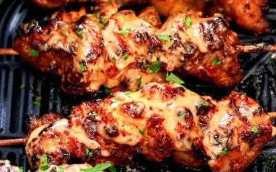 Air Fryer Bang Bang Chicken Skewers served on a plate with dipping sauce