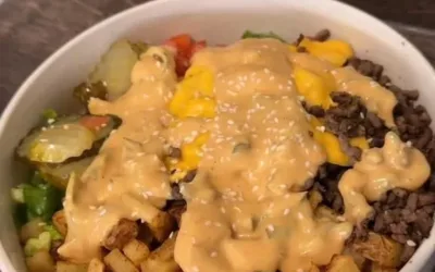 Delicious burger in a bowl with fresh ingredients and toppings