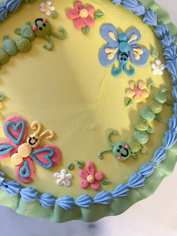Colorful cake by artist Jordan Mulloy showcasing spring themes and playful designs.