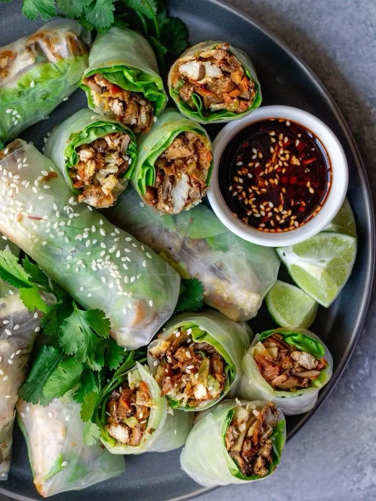 Crispy Chicken Spring Rolls served with dipping sauce on a plate