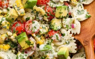 A vibrant bowl of Cilantro Lime Pasta Salad topped with fresh cilantro and lime.