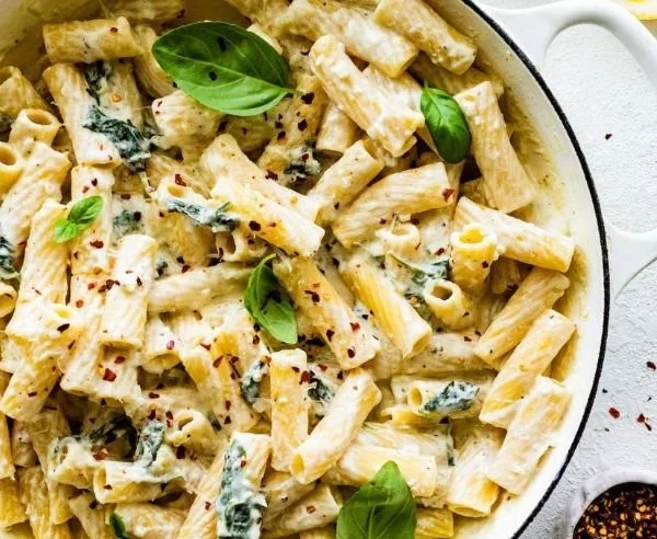 Creamy lemon ricotta pasta dish garnished with fresh herbs