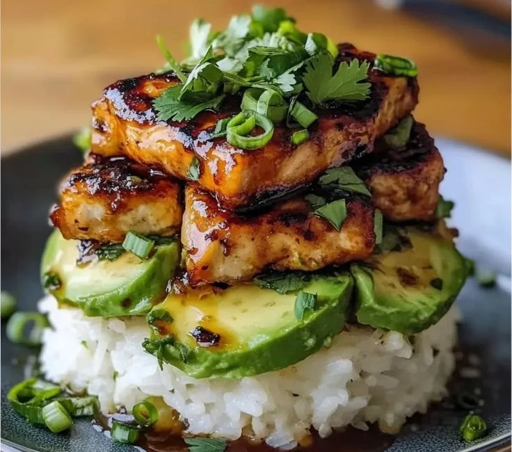 Honey lime chicken served with avocado rice stack on a plate