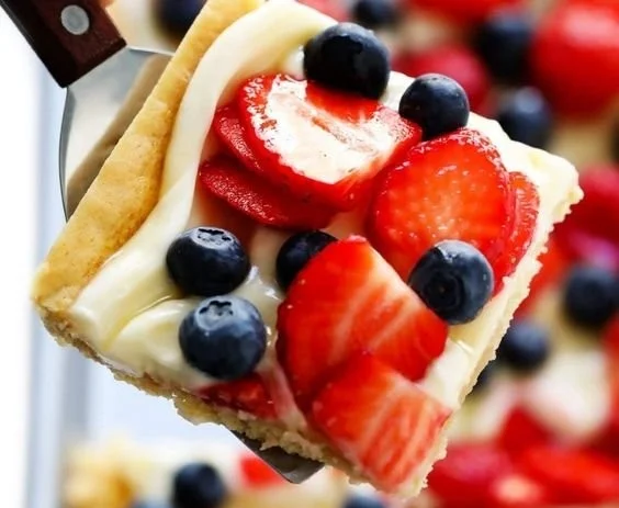 Colorful easy fruit pizza topped with fresh fruits on a cookie crust