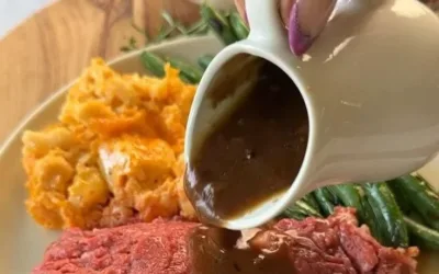 Delicious Garlic Butter Prime Rib served with herbs and sides.