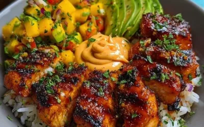 Grilled maple sriracha chicken bites served with coconut rice and mango avocado salsa