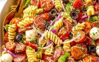 Bowl of colorful legendary pasta salad with fresh vegetables and dressing