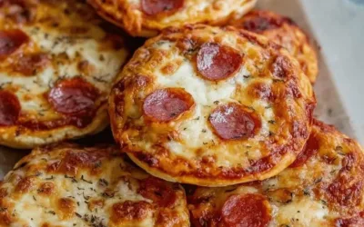 Mini lunchbox pizzas served on a vibrant plate for a fun snack