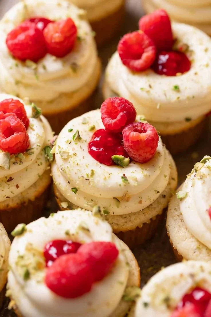 Moist lemon cupcakes with raspberry filling topped with lemon frosting