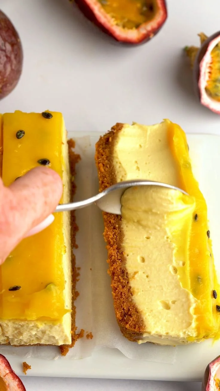 No-bake passion fruit cheesecake topped with fresh passion fruit on a graham cracker crust