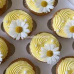 pastel yellow cupcakes with daisies and pearls 2026 03 16 033330 576x1024 1