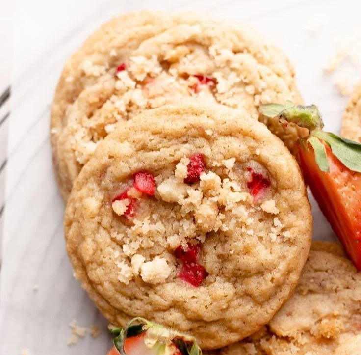 Freshly baked strawberry shortcake cookies with strawberries and whipped cream