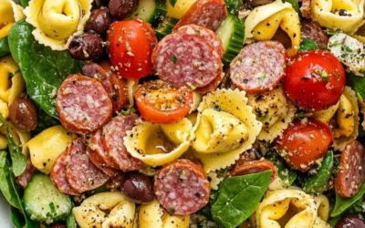 Colorful tortellini salad with vegetables and dressing in a bowl