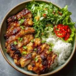 Plate of Vietnamese lemongrass chicken served with rice and vegetables
