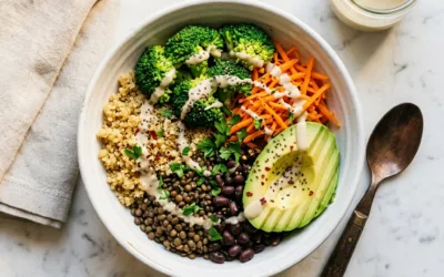 Fiber maxxing for weight loss high-fiber grain bowl with lentils, quinoa, black beans, broccoli, and avocado on white marble