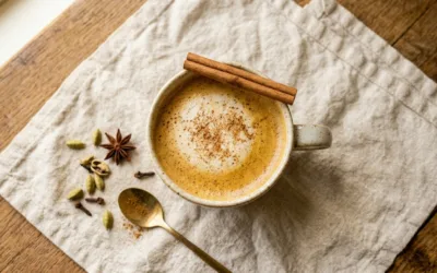 Sanjay Gupta Chai Tea Recipe served in a mug with cinnamon and cardamom on linen